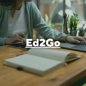 Photo of a woman working on a laptop with a tablet and journal. Text overlay, "Ed2Go."