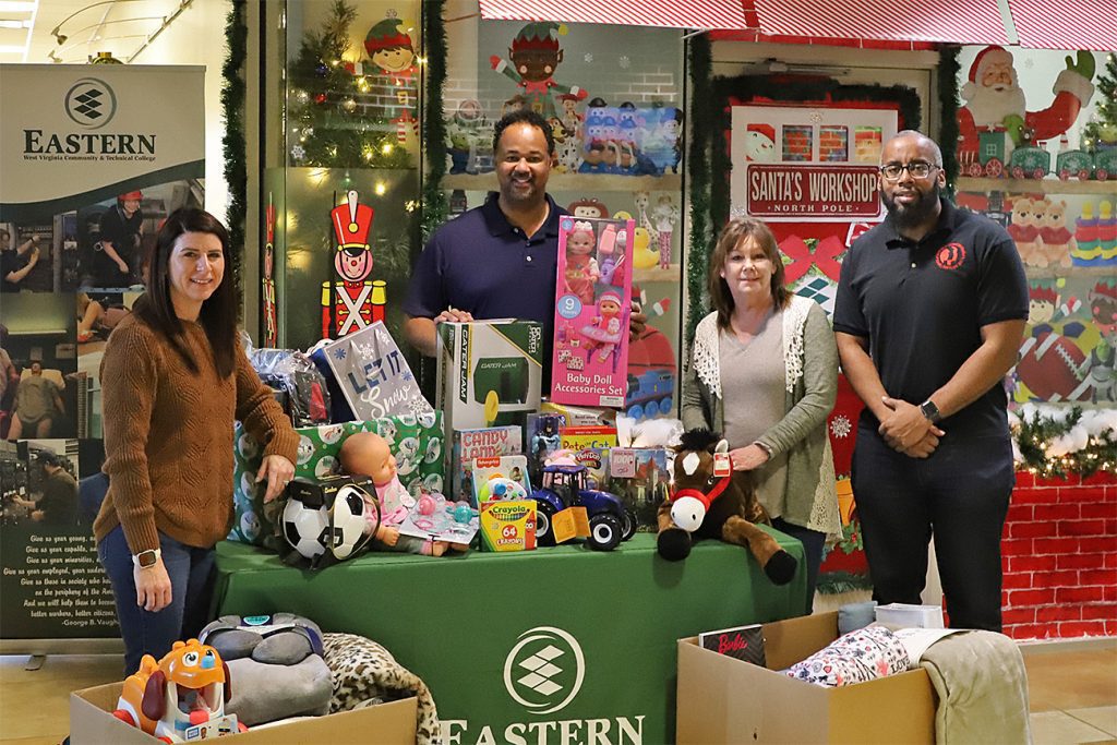 A group of four people displaying toys.