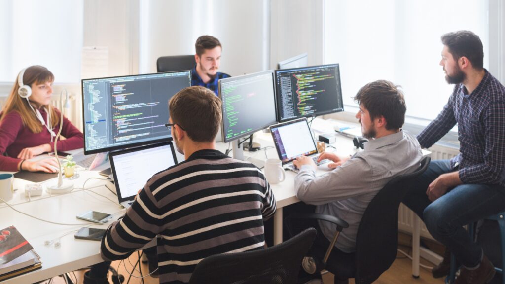 Photo of people sitting at computers.