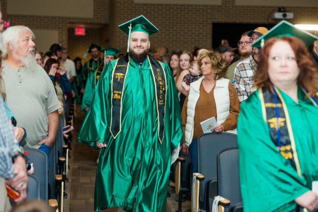 Photo of Eastern graduate walking down aisle.